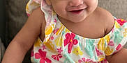 Fatima joined the competition — help win amazing prizes! toddler, child, smiling, sitting, colorful_clothing, floral_pattern, couch, indoors, cute, happy, portrait, young_child, baby, short_hair, bright, comfortable, playful, skin, one_person, casual