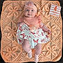 baby, infant, child, smiling, dress, headband, blanket, knitted, milestone_card, 4_months_old, butterfly_pattern, pink, peach, cute, happy, socks, lying_down, portrait, indoor, person