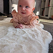 Luna joined the competition — help win amazing prizes! baby, infant, child, portrait, smiling, cute, fluffy_rug, heart_pattern, pink_clothing, indoor, carpet, furniture, shelf, sunlight, happy, toddler, person, head, skin, expression
