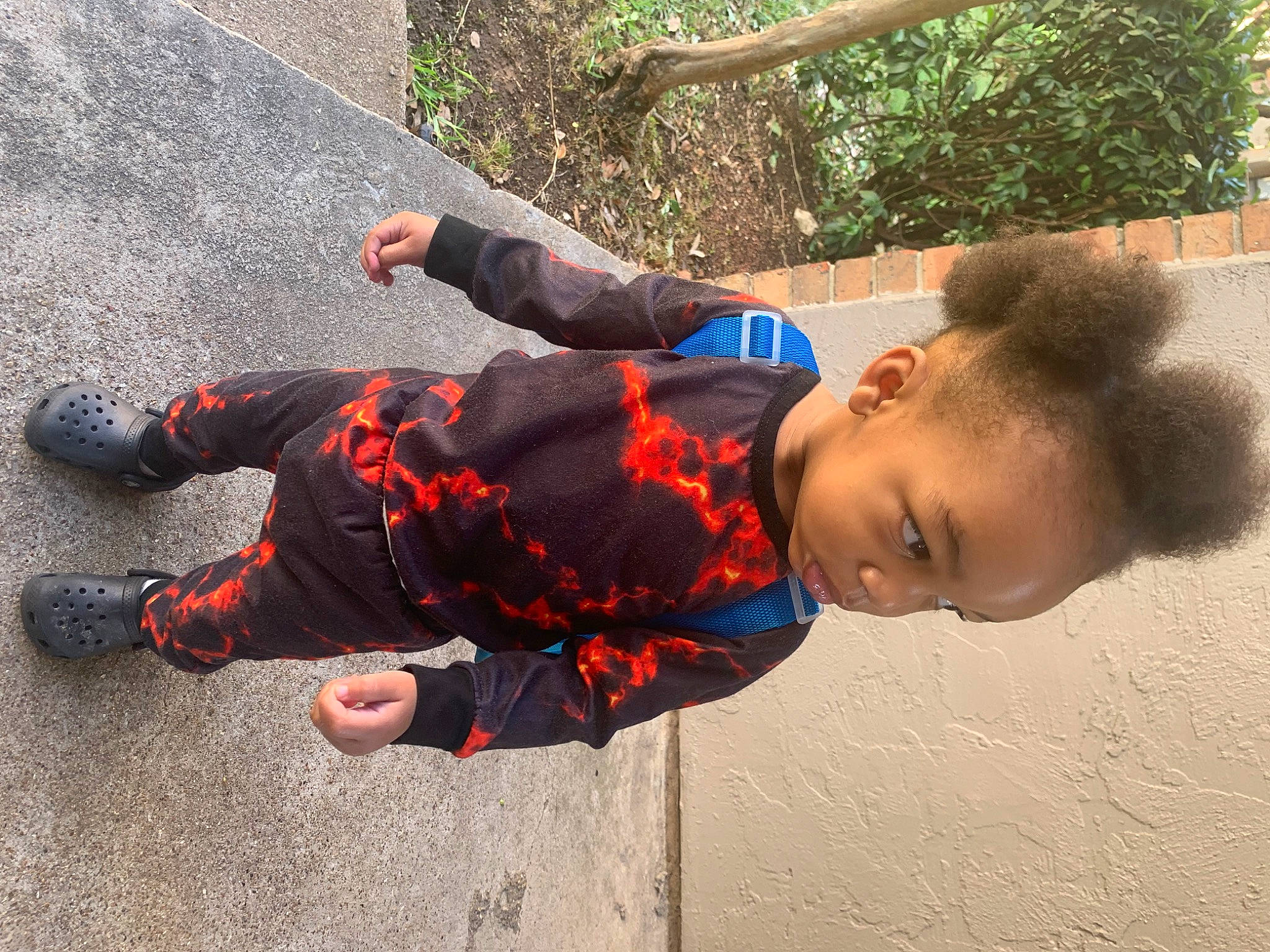 Joziah is registered to the contest to win money with this photo: child, concrete, fun, grass, happy, leisure, pattern, person, play, shadow, sitting, sneakers, soil, toddler, tree, walking_shoe, water