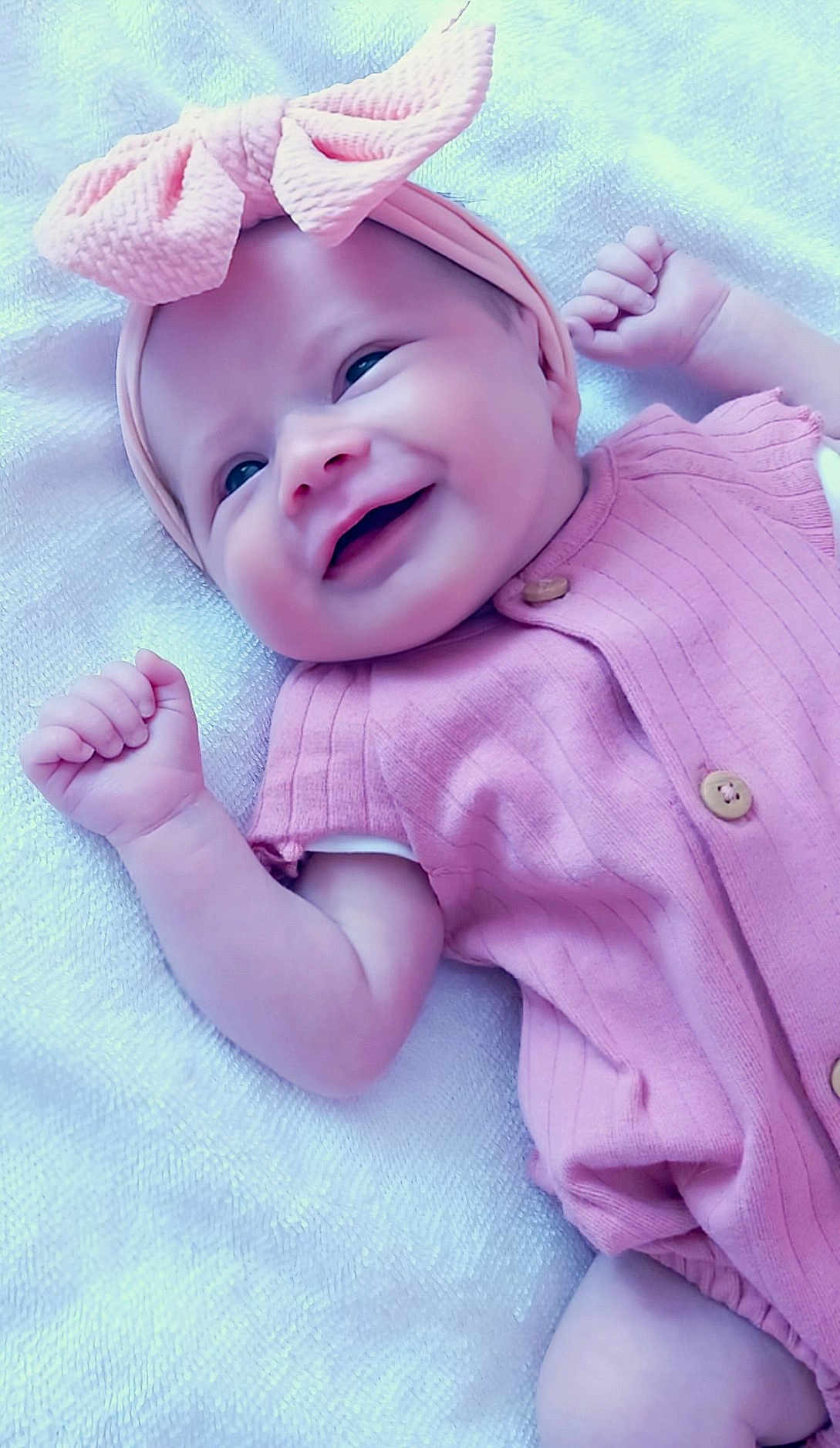 Rayne joined the competition — help win amazing prizes! baby, smiling, infant, pink_bow, headband, pink_outfit, blanket, happy, cute, portrait, child, newborn, soft_texture, clothing, fist, lying_down, baby_girl, cheerful, closeup, adorable