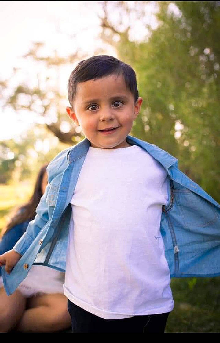 Emilio is registered to the contest to win money with this photo: child, cool, denim, electric_blue, flash_photography, gesture, grass, happy, joy, leisure, people_in_nature, person, plant, recreation, sitting, sleeve, smile, street_fashion, sunlight, t_shirt