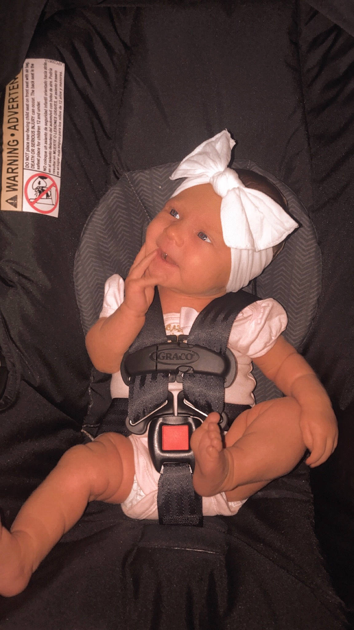 Victoria is registered to the contest to win money with this photo: auto_part, baby, baby_carriage, baby_products, baby_toddler_clothing, car_seat, cheek, comfort, finger, flash_photography, hat, headwear, knee, lap, leg, nail, person, sitting, smile, thigh