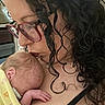 Ella joined the competition — help win amazing prizes! woman, newborn, baby, curly_hair, glasses, blanket, floral_pattern, skin, face, hand, love, tenderness, affection, closeup, indoor, person, family, mother, child, sleeping