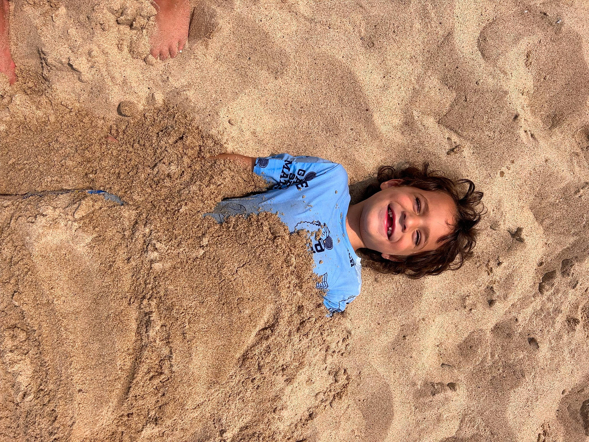 Emilio is registered to the contest to win money with this photo: aeolian_landform, beach, coast, dune, electric_blue, fun, geology, happy, joy, landscape, leisure, mud, people_in_nature, person, play, recreation, sand, shadow, singing_sand, smile