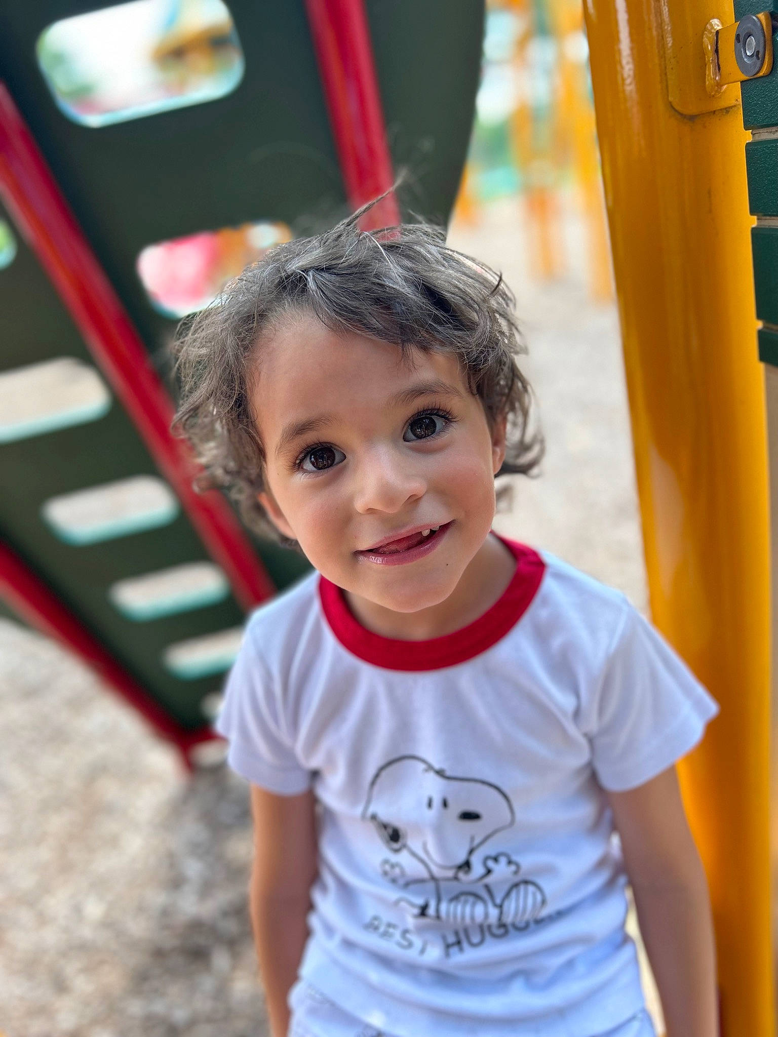 Emilio is registered to the contest to win money with this photo: baby, child, city, fun, happy, human_settlement, joy, laugh, leisure, outdoor_play_equipment, person, play, playground, playground_slide, recreation, sleeve, smile, swing, t_shirt, toddler