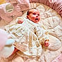 Ariella joined the competition — help win amazing prizes! baby, child, comfort, cozy, cute, dress, face, floral_pattern, hand, happy, head, indoors, infant, lying_down, pink, plush_cushion, portrait, smiling, soft_texture, young_child
