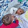 Amaiah is registered to the contest to win money with this photo: baby, infant, child, blanket, quilt, hat, clothing, red_onesie, gray_outfit, bow_hat, face, head, skin, hand, outdoor, floor, textile, pattern, cute, together