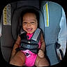baby, car_seat, child, infant, smiling, happy, seatbelt, pink_clothing, cute, safety, indoors, child_seat, person, young_child, portrait, baby_girl, straps, secure, face, cheerful