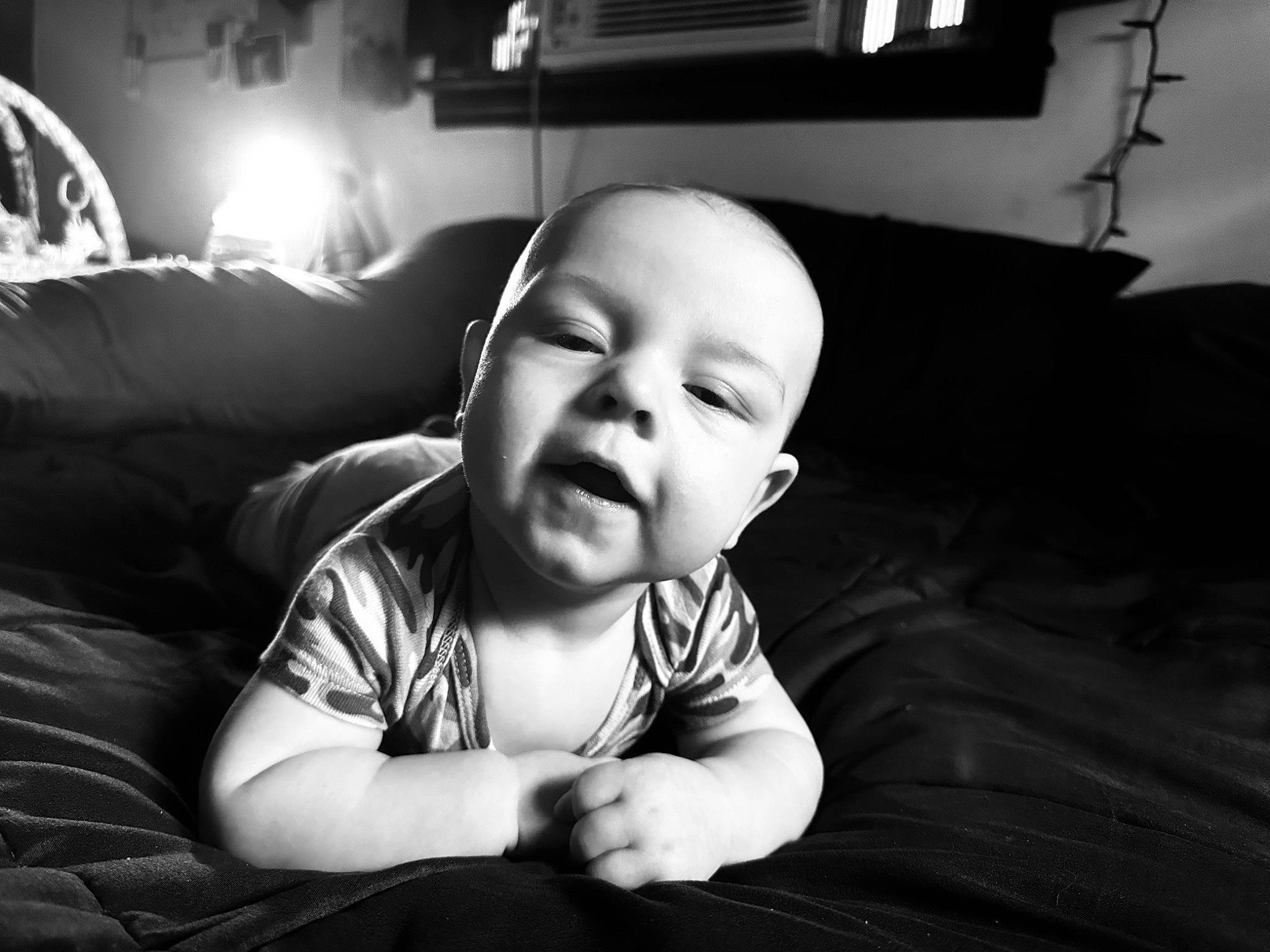 Niklaus is registered to the contest to win money with this photo: baby, baby_toddler_clothing, black, black_and_white, cheek, comfort, couch, darkness, flash_photography, fun, happy, lamp, light, lighting, monochrome, monochrome_photography, person, room, smile, style