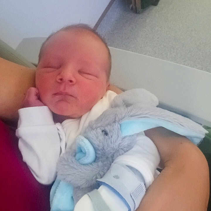 Frankie is registered to the contest to win money with this photo: newborn, baby, sleeping, infant, stuffed_animal, plush_toy, blue, white_clothing, arm, indoor, person, soft_toy, resting, peaceful, child, cuddle, comfort, bedroom, human, portrait