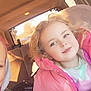 Avia joined the competition — help win amazing prizes! blonde_hair, car_interior, car_seat, casual_clothing, child, curly_hair, daylight, holding_object, person, pink_jacket, portrait, seat, seatbelt, smile, sunlight, vehicle, warm_light, white_jacket, window, young_child