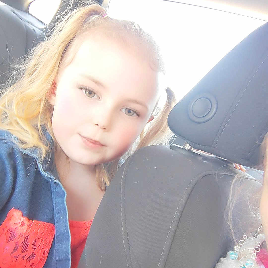 Avia joined the competition — help win amazing prizes! backseat, blonde_hair, blue_jacket, car, casual, child, childhood, face, girl, headrest, interior, pigtails, portrait, red_dress, seat, seatbelt, smile, sunlight, vehicle, young