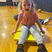 Avia joined the competition — help win amazing prizes! child, blonde_hair, pink_shirt, yellow_scooter, gymnasium, basketball, kids, wooden_floor, play, boots, leggings, sports, indoor, fun, active, smiling, happy, exercise, recreation, leisure