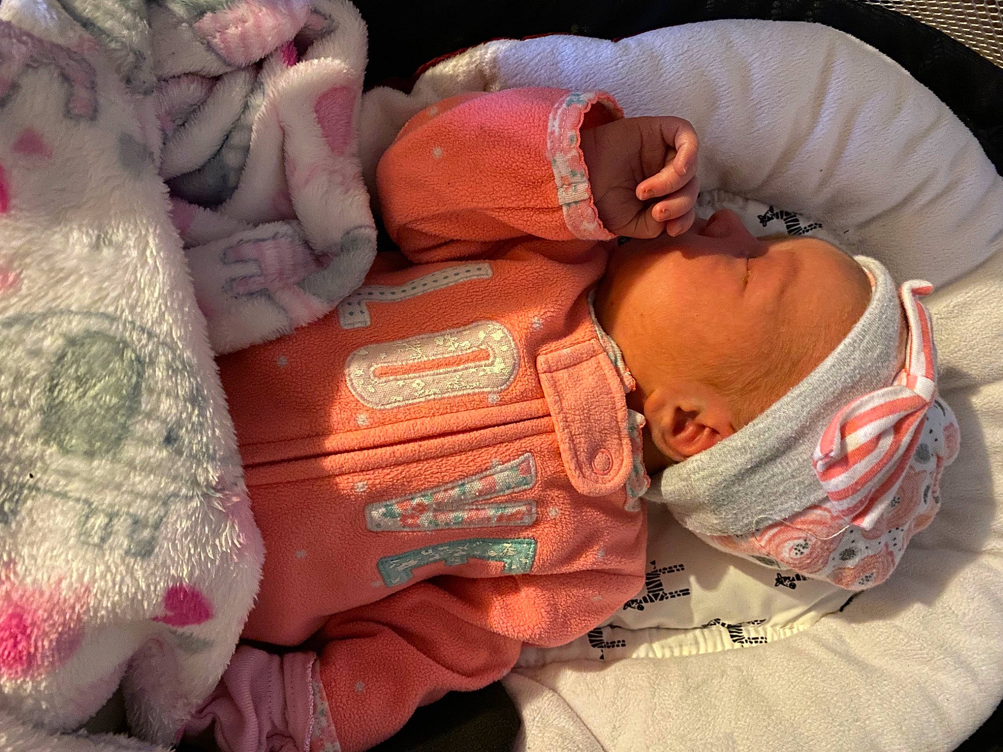 Kinsleigh is registered to the contest to win money with this photo: baby, baby_products, baby_toddler_clothing, carmine, child, comfort, finger, flesh, hat, headgear, linens, magenta, peach, person, personal_protective_equipment, pink, room, sitting, sleeve, thumb