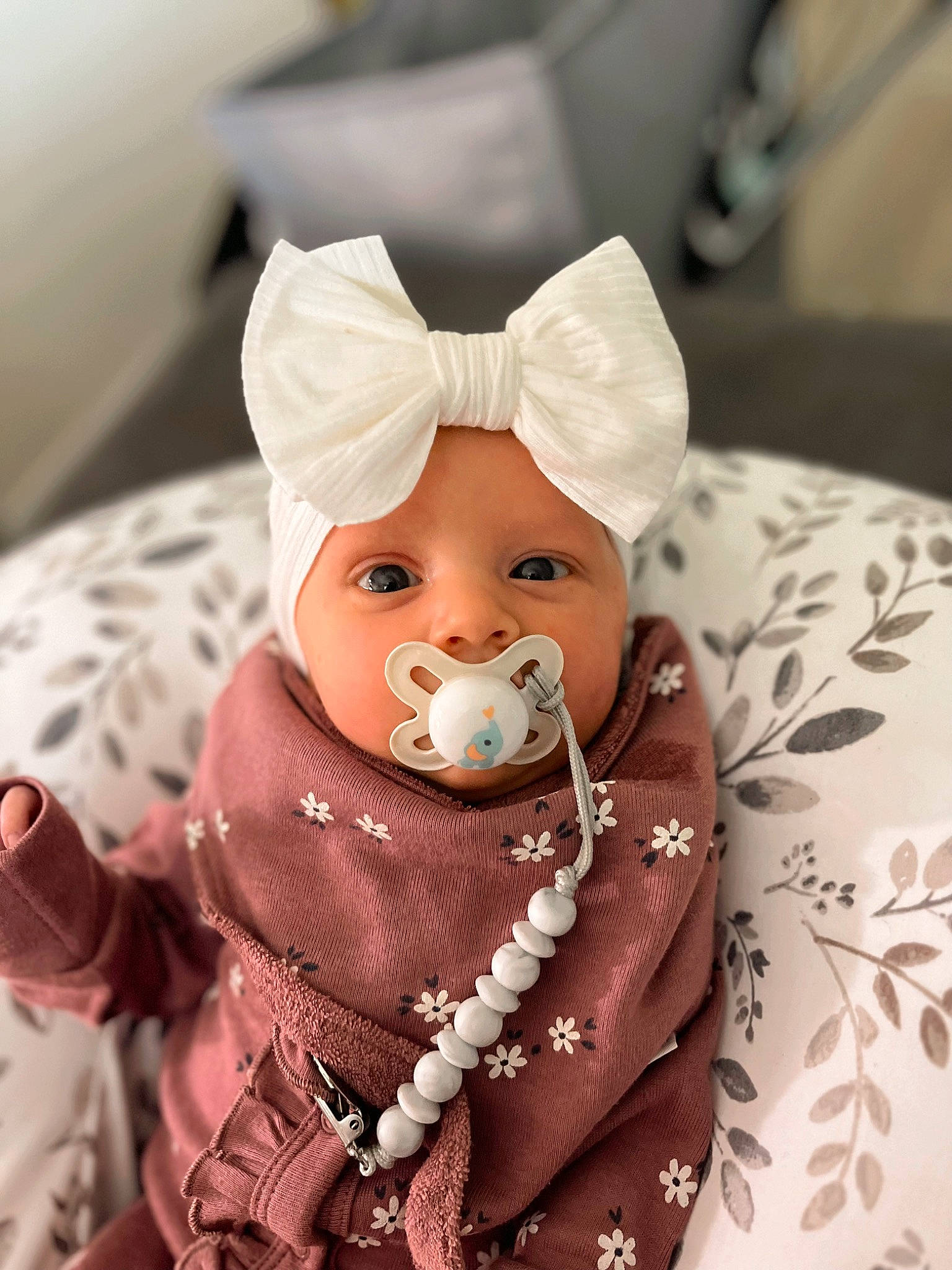 Brinley is registered to the contest to win money with this photo: art, baby, carmine, child, doll, event, fashion_accessory, figurine, fur, happy, hat, headwear, human_body, jewellery, ornament, peach, person, sitting, sweetness, toy