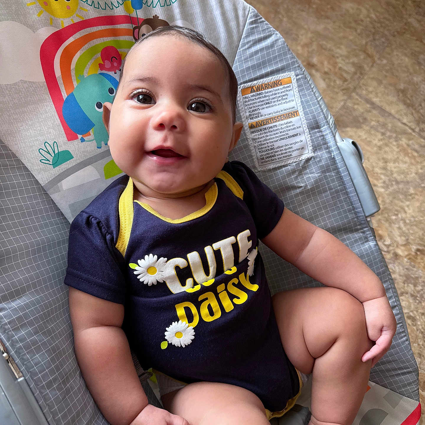 Jeanieliz is registered to the contest to win money with this photo: baby, baby_chair, child, clothing, colorful, cute, daisy, face, floor, foot, hand, happy, indoor, infant, onesie, person, playful, portrait, sitting, smiling
