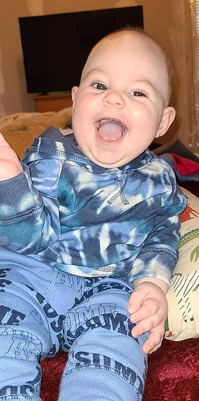 Brady is registered to the contest to win money with this photo: arm, cheek, comfort, eye, face, facial_expression, hairstyle, happy, head, human_body, iris, lip, mouth, nose, organ, person, product, skin, sleeve, smile
