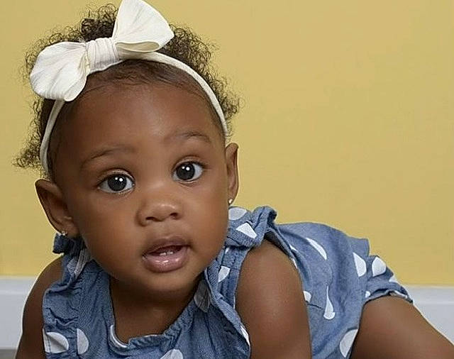 Brooklyn is registered to the contest to win money with this photo: baby_toddler_clothing, black_hair, cheek, child, chin, ear, eye, eyebrow, eyelash, fashion_accessory, flash_photography, forehead, hairstyle, happy, headband, headpiece, iris, jewellery, nose, person