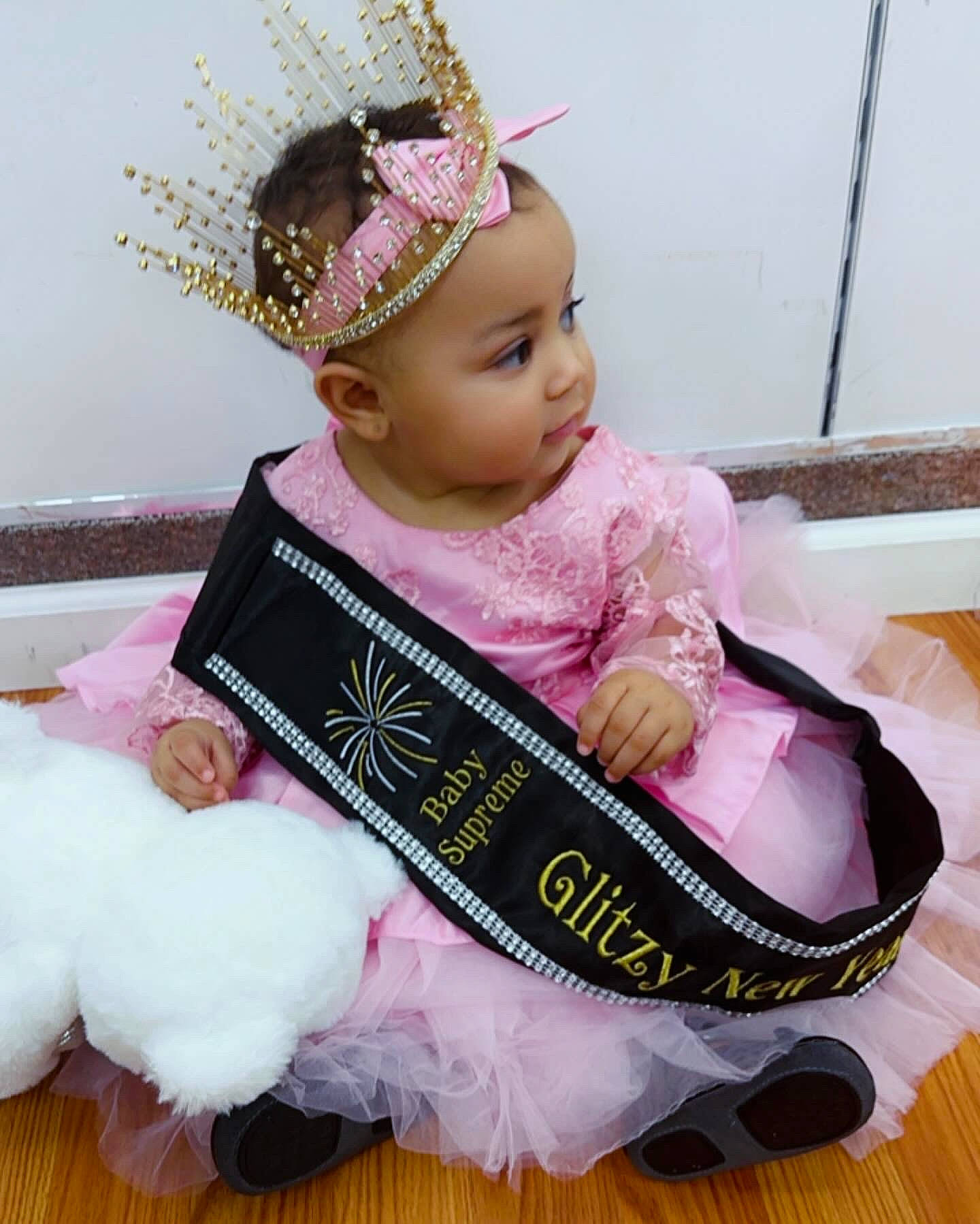 Arabella is registered to the contest to win money with this photo: baby, baby_toddler_clothing, birthday, child, costume, event, eyelash, fashion_accessory, hair_accessory, happy, headband, headgear, headpiece, headwear, jewellery, magenta, person, pink, sitting, sleeve