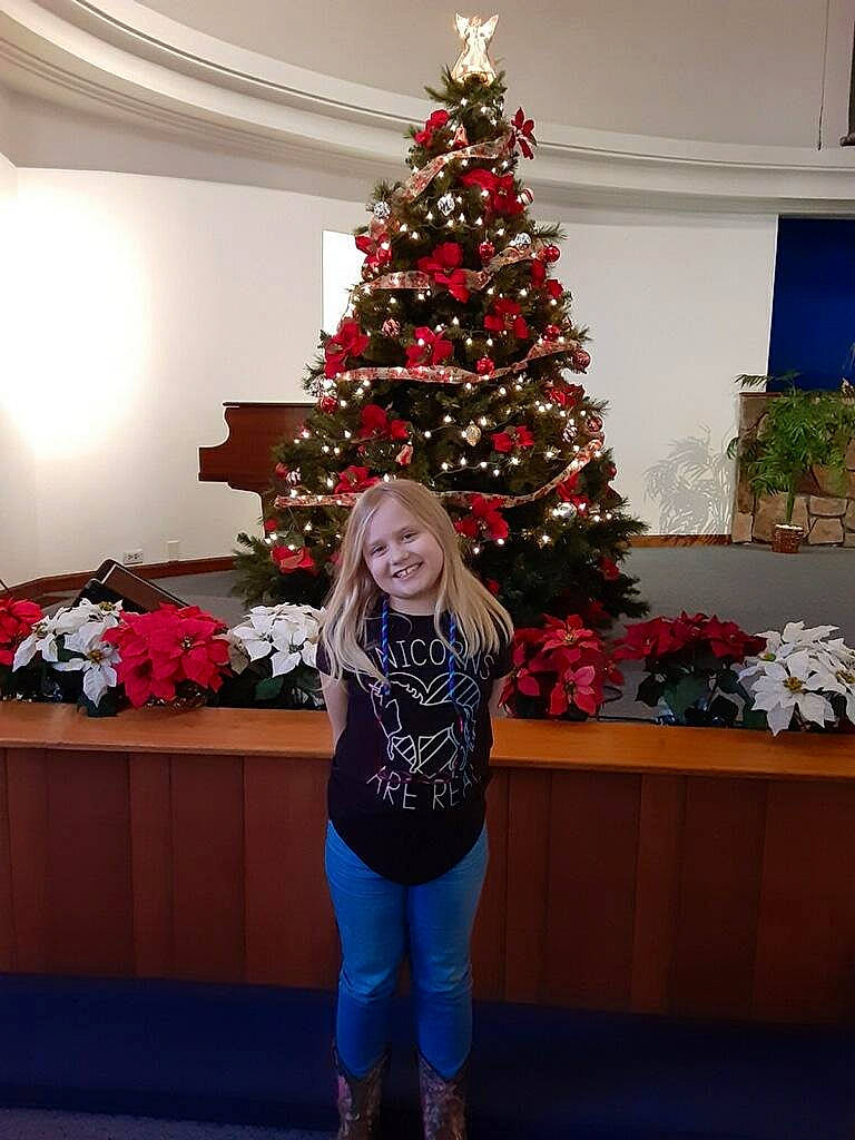 Virginia is registered to the contest to win money with this photo: christmas, christmas_decoration, christmas_eve, christmas_ornament, christmas_tree, conifer, event, holiday, holiday_ornament, home, houseplant, interior_design, joy, leaf, person, plant, red, sky, standing, tree