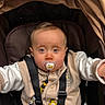 Liam participe au concours pour gagner de l'argent avec cette photo : baby, pacifier, stroller, child, infant, cute, face, blue_eyes, clothing, beige, white, straps, sitting, closeup, portrait, toddler, accessory, indoor, expression, cute_face