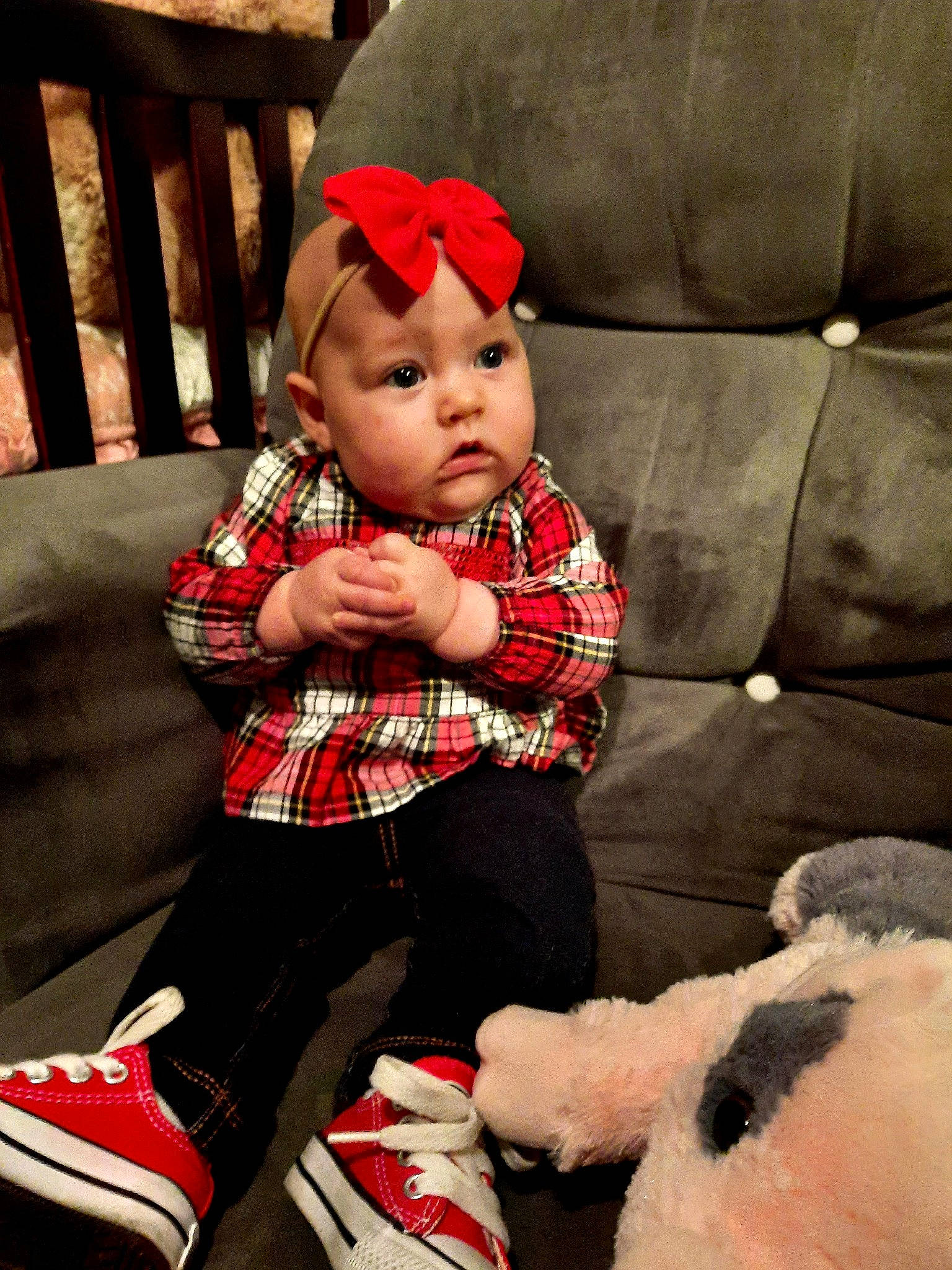 Lillyana is registered to the contest to win money with this photo: baby, baby_toddler_clothing, comfort, couch, face, furniture, headwear, holiday, knee, lap, leg, living_room, person, plaid, red, shoe, sleeve, sock, tartan, textile