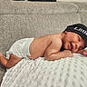 newborn, baby, infant, sleeping, portrait, couch, blanket, beanie, diaper, indoor, cozy, peaceful, curled_up, lying_down, face, hands, feet, textile, furniture, photography