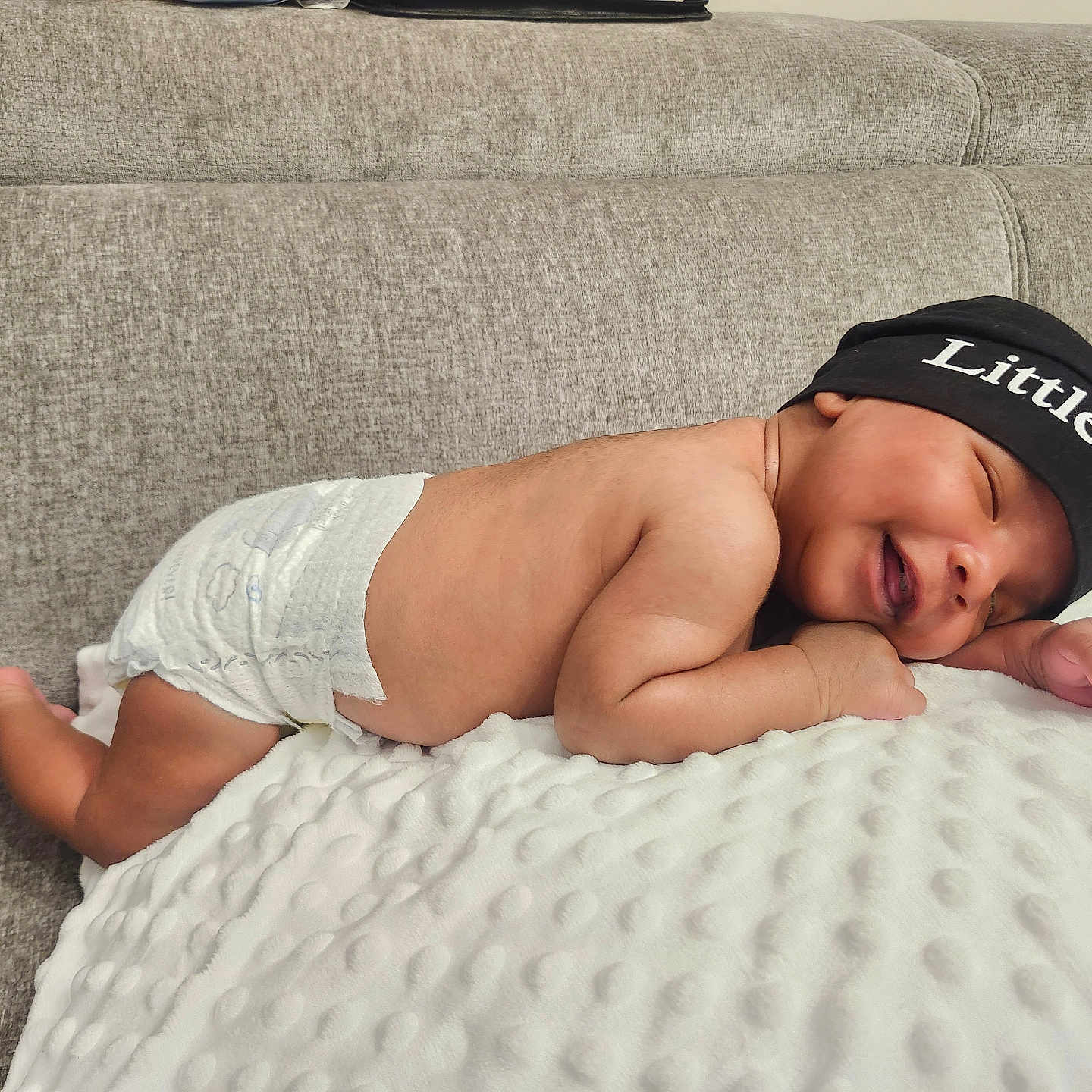 Matteo is registered to the contest to win money with this photo: newborn, baby, infant, sleeping, portrait, couch, blanket, beanie, diaper, indoor, cozy, peaceful, curled_up, lying_down, face, hands, feet, textile, furniture, photography