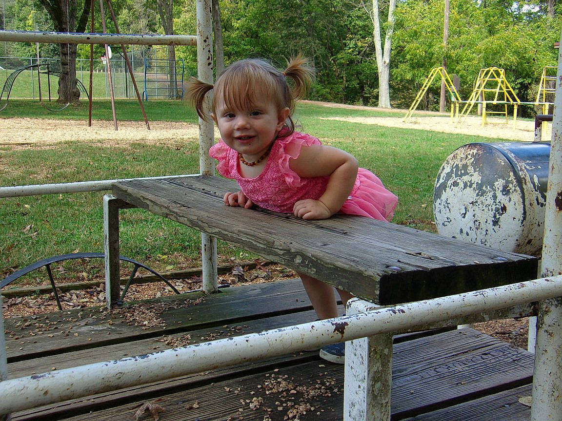 Meiah is registered to the contest to win money with this photo: child, fun, girl, grass, joy, outdoor_play_equipment, person, plant, play, playground, public_space, recreation, toddler, tree, vacation