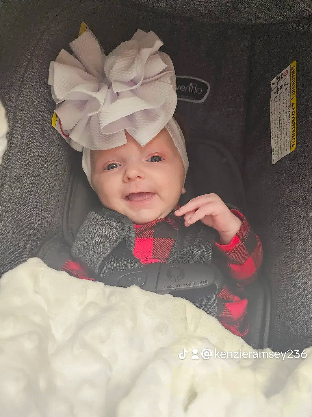 Heavenly is registered to the contest to win money with this photo: baby, baby_toddler_clothing, beanie, bonnet, child, comfort, costume_accessory, fashion_accessory, headwear, linens, outerwear, person, room, sitting, sleeve, smile, toddler