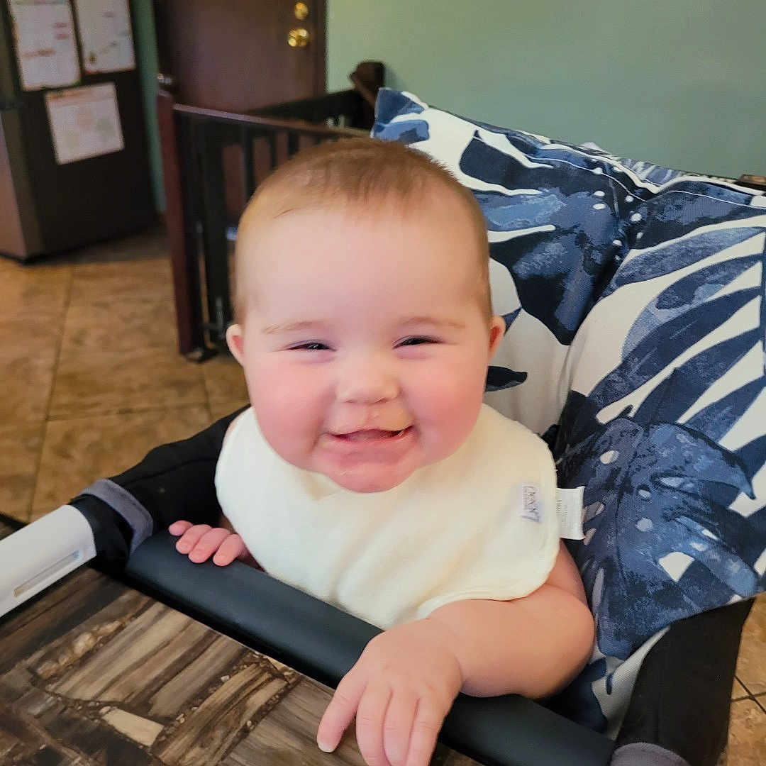 Hunter is registered to the contest to win money with this photo: baby, bed, chair, clothing, couch, crib, cushion, face, furniture, happy, head, homedecor, indoors, infantbed, laughing, person, photography, portrait, smile, t_shirt
