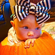 Hazelynn joined the competition — help win amazing prizes! baby, bow, pumpkin, orange, child, indoor, face, hand, curious, headband, portrait, young_child, cute, autumn, seasonal, holiday, closeup, expression, infant, decor