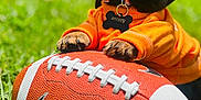 Smokey joined the competition — help win amazing prizes! puppy, dog, football, nike, orange_sweater, grass, outdoor, sunlight, happy, cute, pet, playing, animal, tongue_out, paw, collar, tag, nature, smiling, closeup
