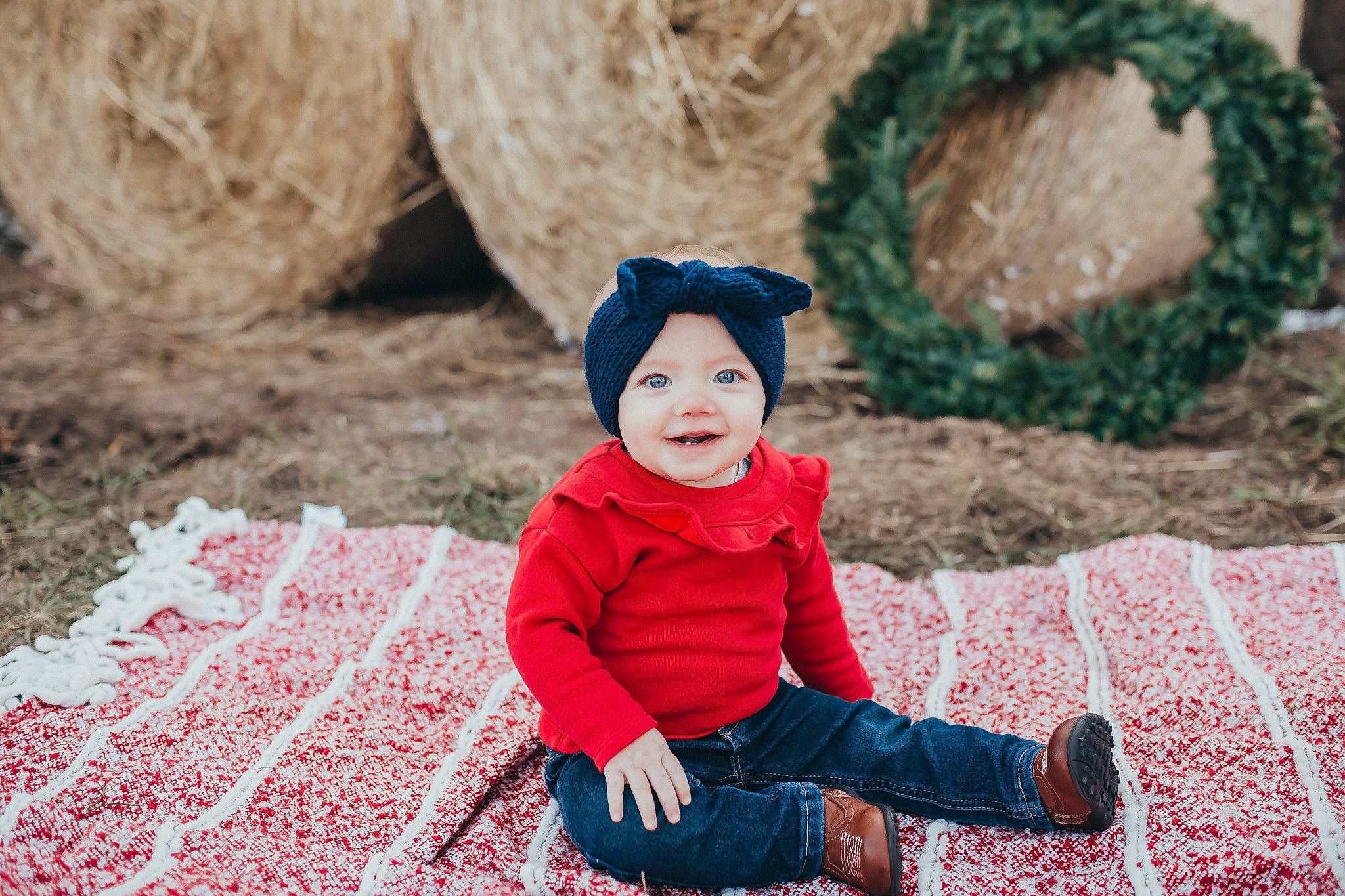 Adilynn is registered to the contest to win money with this photo: baby, beauty, child, eye, face, fun, happy, headgear, outerwear, people, person, photograph, photography, portrait_photography, red, sitting, skin, smile, toddler, tree