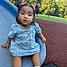 casual_clothing, child, curious, cute, daylight, denim_dress, fun, grass, outdoor, park, person, pink_bows, play, playground, sitting, slide, toddler, trees, white_socks, young_child