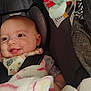 Ella is registered to the contest to win money with this photo: baby, smile, car_seat, blanket, toy, infant, happy, face, clothing, child, seatbelt, indoor, cute, person, comfort, cozy, head_support, pink, blue, soft_toy