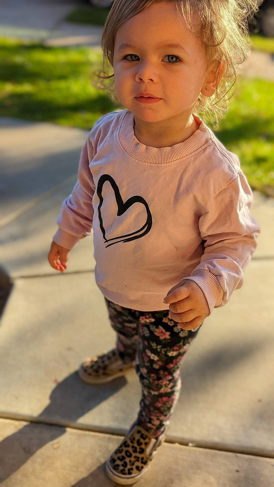 Lilah is registered to the contest to win money with this photo: baby_toddler_clothing, blond, child, eye, facial_expression, grass, happy, human_leg, leggings, lip, neck, pattern, person, skin, sleeve, smile, sportswear, t_shirt, thigh, toddler