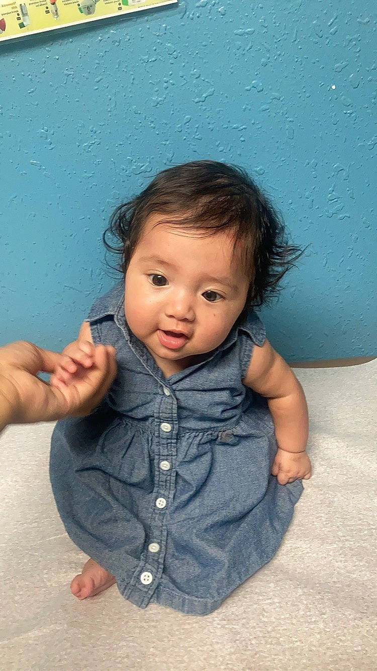 Marianna is registered to the contest to win money with this photo: azure, baby_toddler_clothing, black_hair, cheek, face, finger, flash_photography, gesture, hair, hairstyle, hand, happy, iris, lip, nose, person, skin, sleeve, standing, thumb