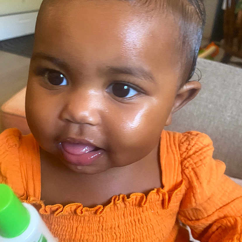 Indigo joined the competition — help win amazing prizes! baby, babylaughing, bodypart, bottle, cosmetics, couch, face, finger, furniture, hand, happy, head, indoors, lipstick, mouth, person, photography, portrait, smile, teeth