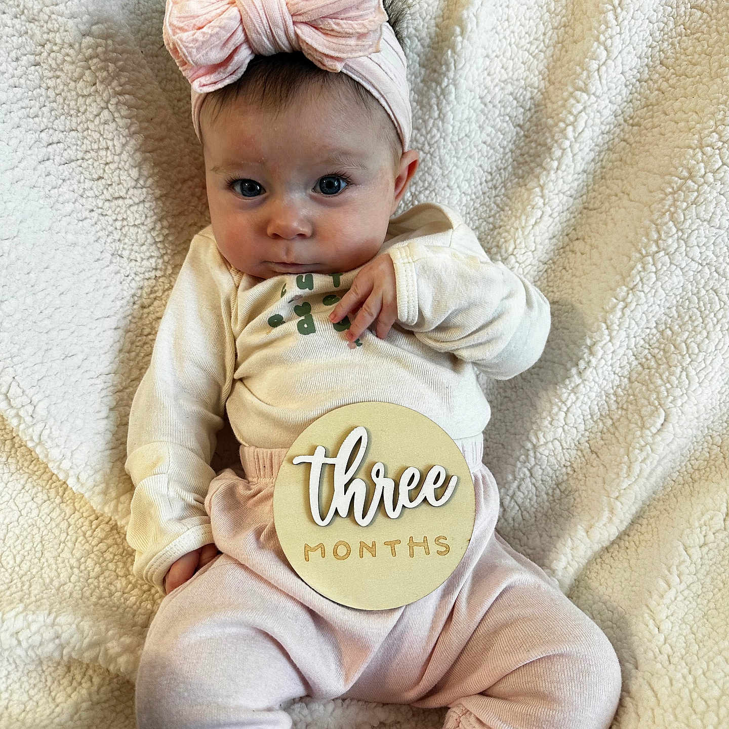 Madilyn is registered to the contest to win money with this photo: baby, blanket, bow, child, clothing, cozy, cute, expression, face, headband, indoors, infant, milestone, person, pink, portrait, sign, sitting, soft_texture, wooden_sign