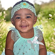 Saroya joined the competition — help win amazing prizes! baby, child, smiling, girl, headband, flower, dress, mint_green, sparkles, outdoor, nature, grass, sunlight, portrait, happy, cute, young_child, sitting, closeup, person