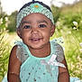 baby, child, smiling, girl, headband, flower, dress, mint_green, sparkles, outdoor, nature, grass, sunlight, portrait, happy, cute, young_child, sitting, closeup, person