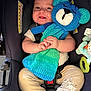 Kolten joined the competition — help win amazing prizes! baby, car_seat, knitted_toy, blue, green, smiling, infant, cute, clothing, beige_pants, deer_design, safety_label, toy, soft_toys, child, happy, indoor, seatbelt, portrait, hands