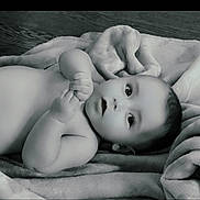 Kolten joined the competition — help win amazing prizes! baby, infant, blanket, soft_texture, lying_down, curious, wide_eyes, hands, skin, face, portrait, monochrome, black_and_white, young_child, cute, peaceful, indoors, newborn, child, resting