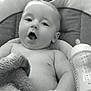 baby, infant, blanket, baby_bottle, seat, cushion, face, mouth_open, skin, arm, head, child, monochrome, indoor, comfort, expression, soft_texture, newborn, relaxing, portrait