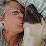 affection, bed, casual, closeup, dog, eyewear, face, fur, glasses, grey_shirt, indoor, mouth, nose, pattern, person, pillow, relaxation, skin, sleeping, tattoo