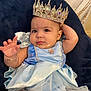 Samadhi joined the competition — help win amazing prizes! baby, child, crown, dress, blue_dress, jewelry, bracelet, earrings, cute, portrait, indoor, sitting, fabric, cushion, accessories, person, young_child, expression, costume, royalty
