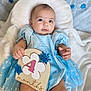 baby, infant, blue_dress, snowflake, sign, 4_months, blanket, cute, portrait, child, smiling, soft_texture, lying_down, earrings, chubby, celebration, indoor, head, hand, foot