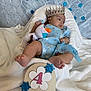 Samadhi joined the competition — help win amazing prizes! baby, infant, crown, blue_dress, plush_toy, olaf, snowflake_decorations, blanket, white_blanket, sign, months, feet, face, portrait, cute, celebration, holiday_theme, child, resting, indoors